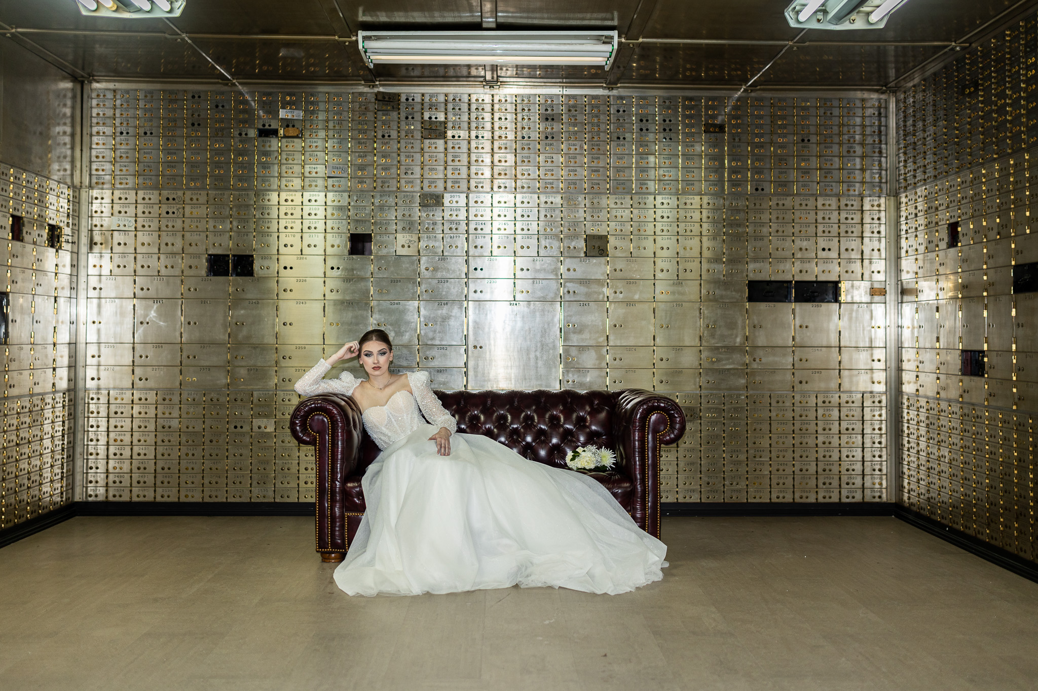 Bride in white dress sitting on the couch in The Treasury captured by Savvy Shoots Photography