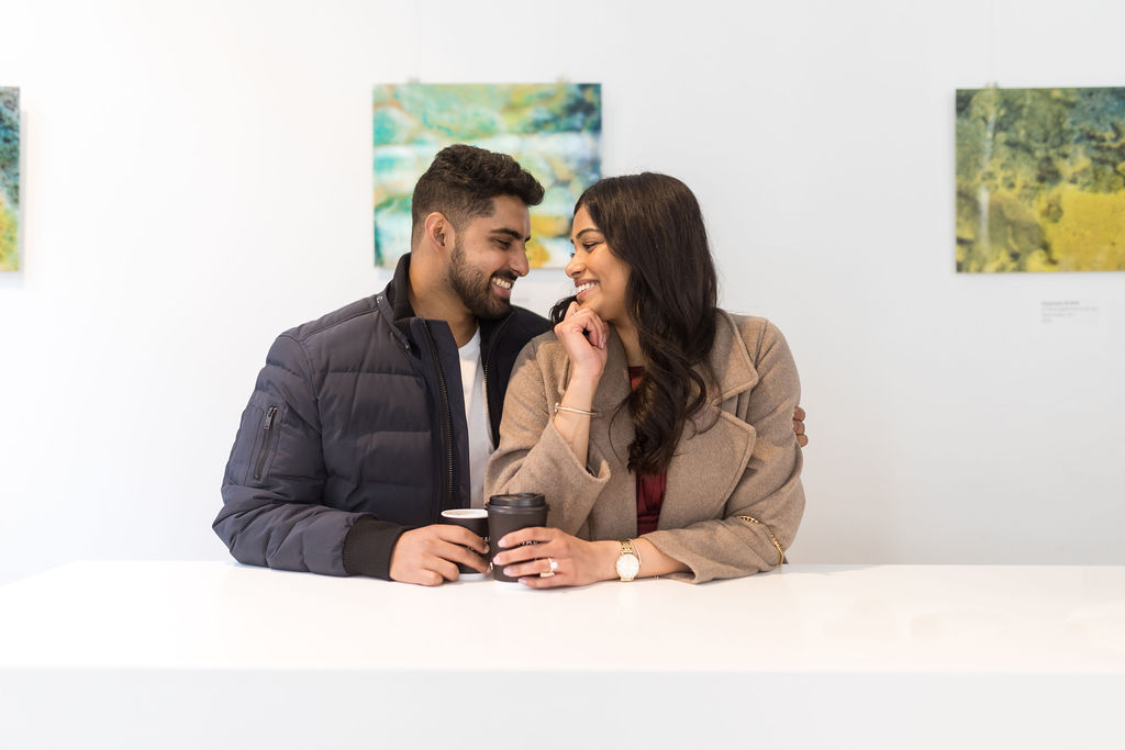 Man and woman in coffee shop engagement photography in Detroit