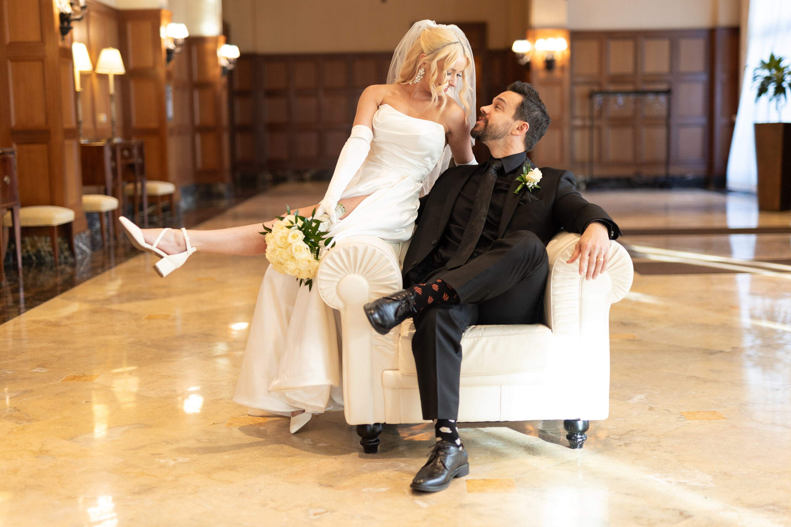 Bride and groom sitting on chair at Royal Park Hotel in Rochester Hills Michigan