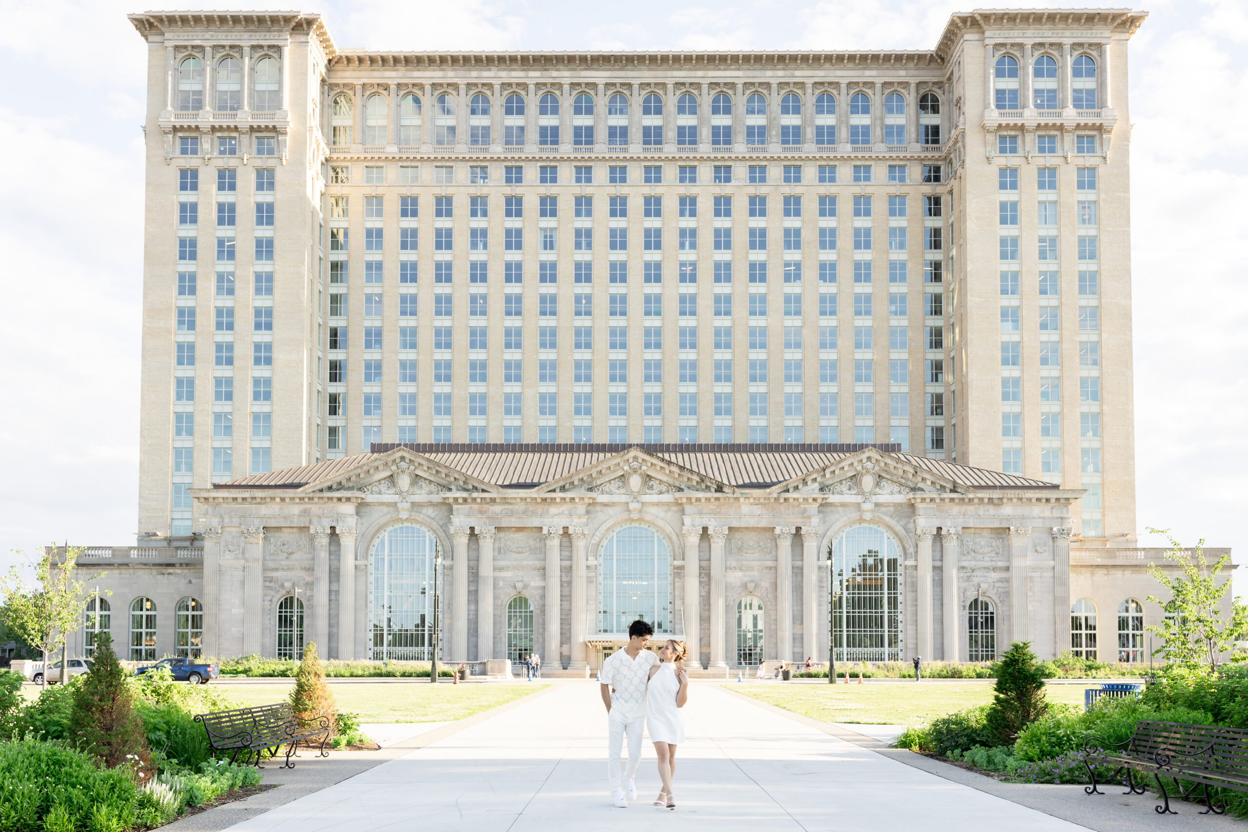 Man and woman walking in front of Michigan Central during Detroit engagement photos