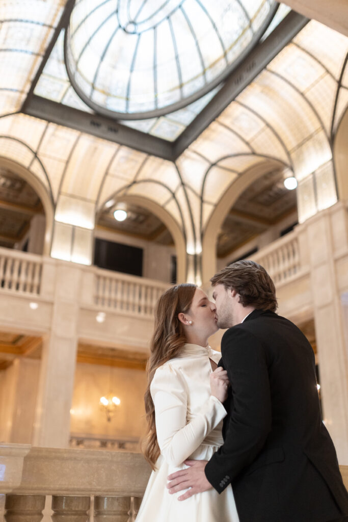 man and woman kissing during engagement photos at Book Tower in Detroit