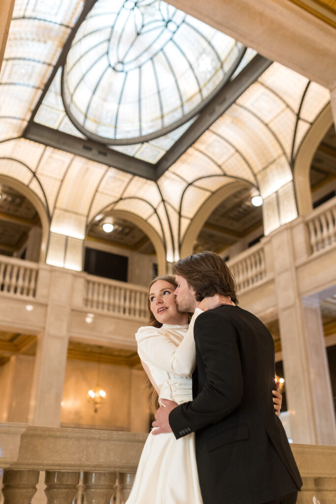 man and woman kissing during engagement photos at Book Tower in Detroit