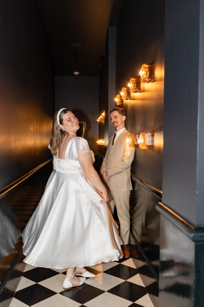 Man and woman posing for engagement photos at Siren Hotel in Detroit