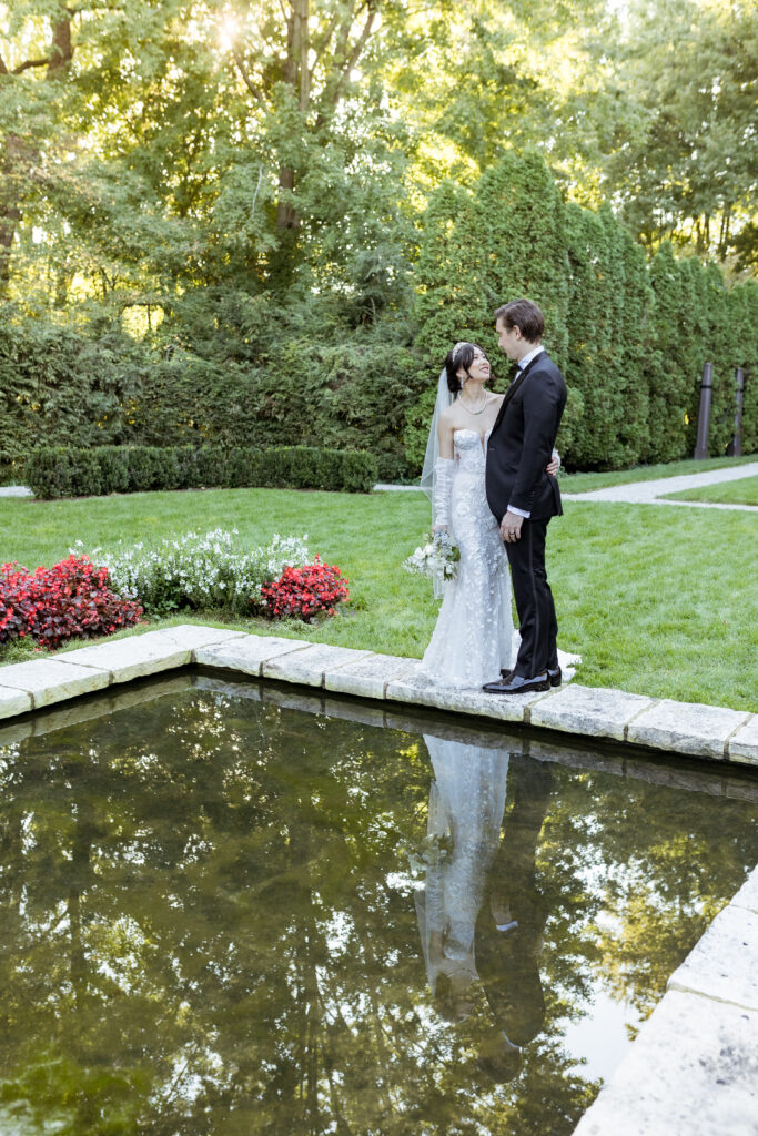 Bride and groom at reflection pond at The Ford House in Grosse Pointe by Wedding Photographer Savvy Shoots Photography