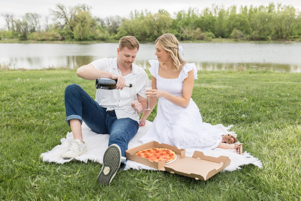 Man and woman drinking champagne during engagement photos in Detroit