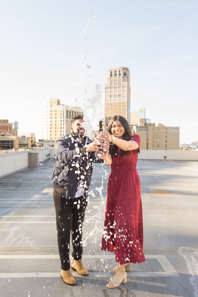 Man and woman spraying champagne after Detroit Porposal