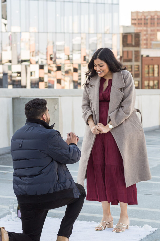 Man proposing to girlfriend on rooftop in Downton Detroit captured by Savvy Shoots Photography