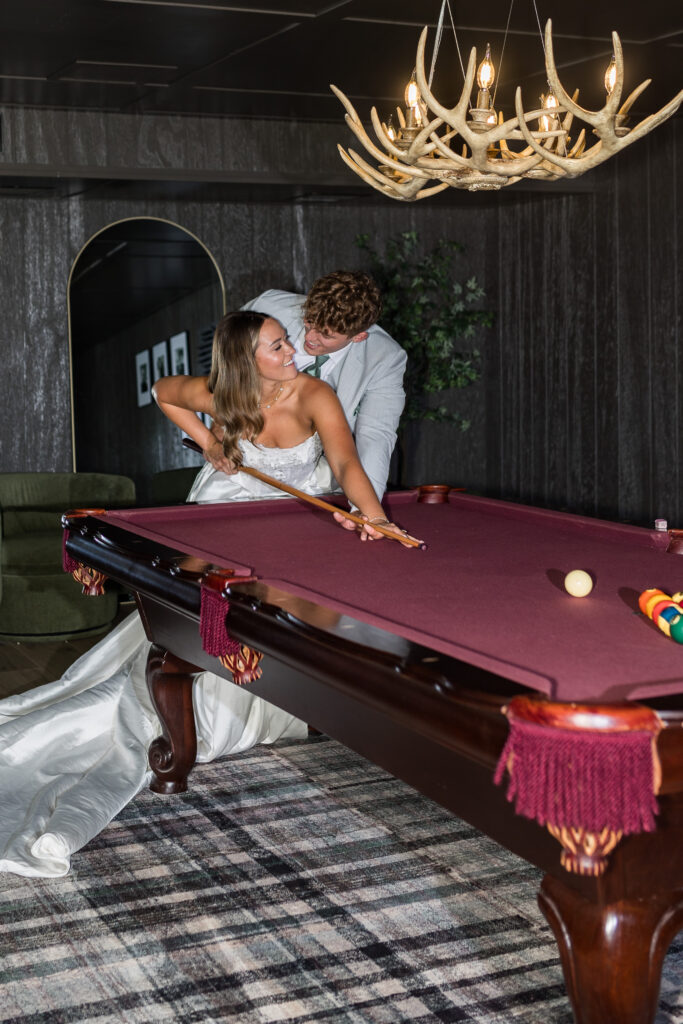 Bride and groom playing pool at Hidden Gove Estate by Wedding Photographer Savvy Shoots Photography