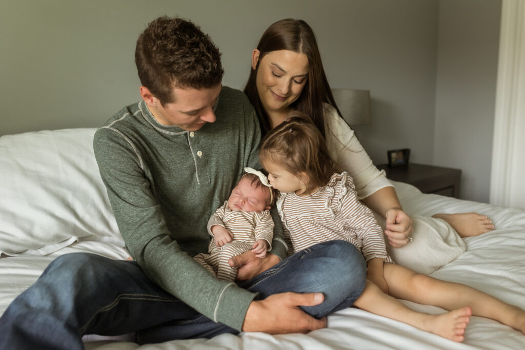 Family taking newborn photography pictures in Shelby Township Michigan