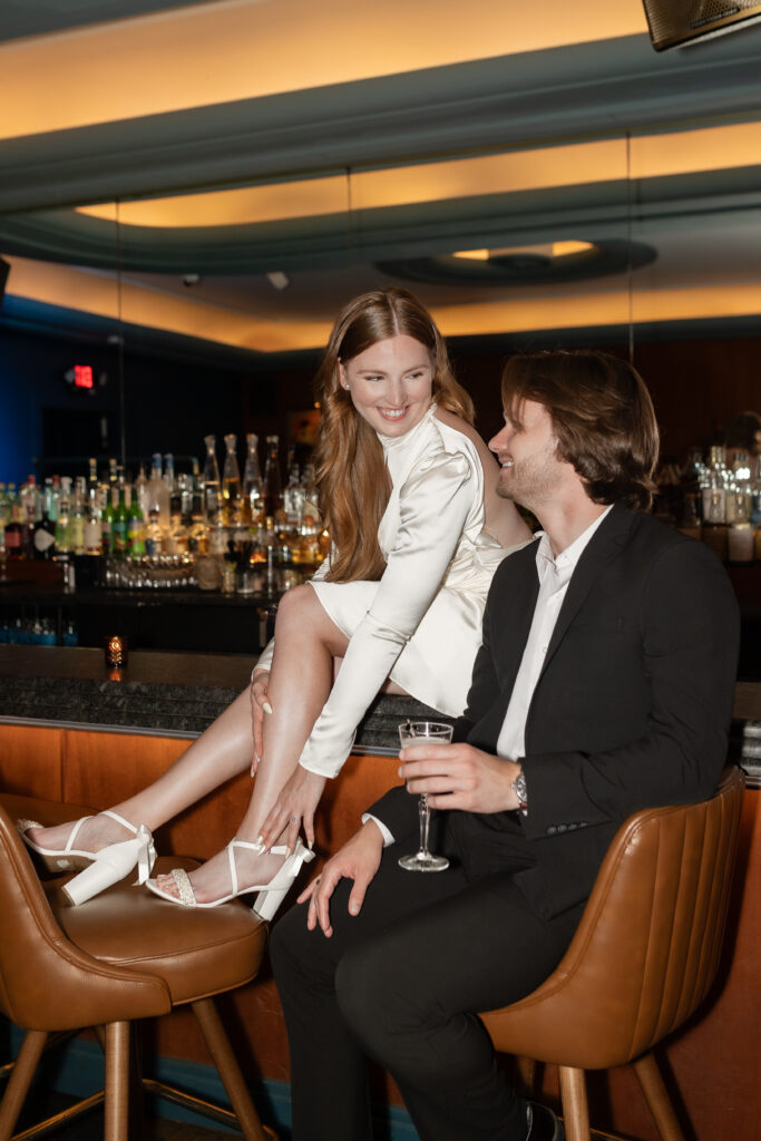 Woman on bar during Detroit engagement photography with Savvy Shoots