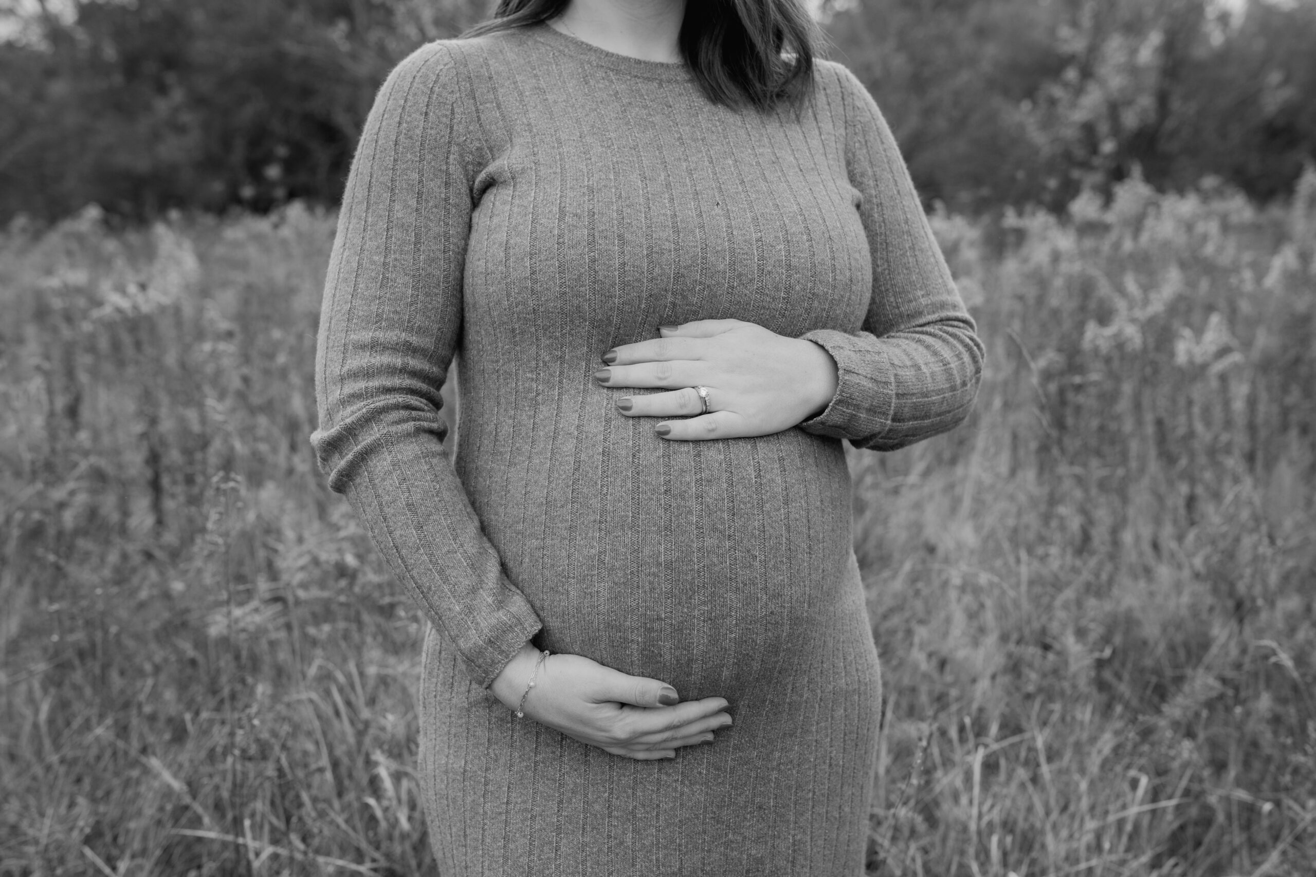 woman holding belly during maternity photography in Oakland County MI