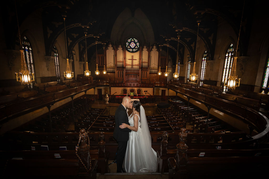 Bride and groom kissing in Detroit church wedding