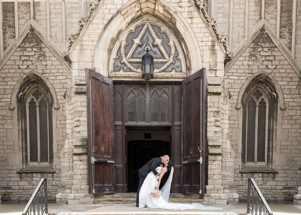 Bride and groom kissing during wedding photography in Detroit
