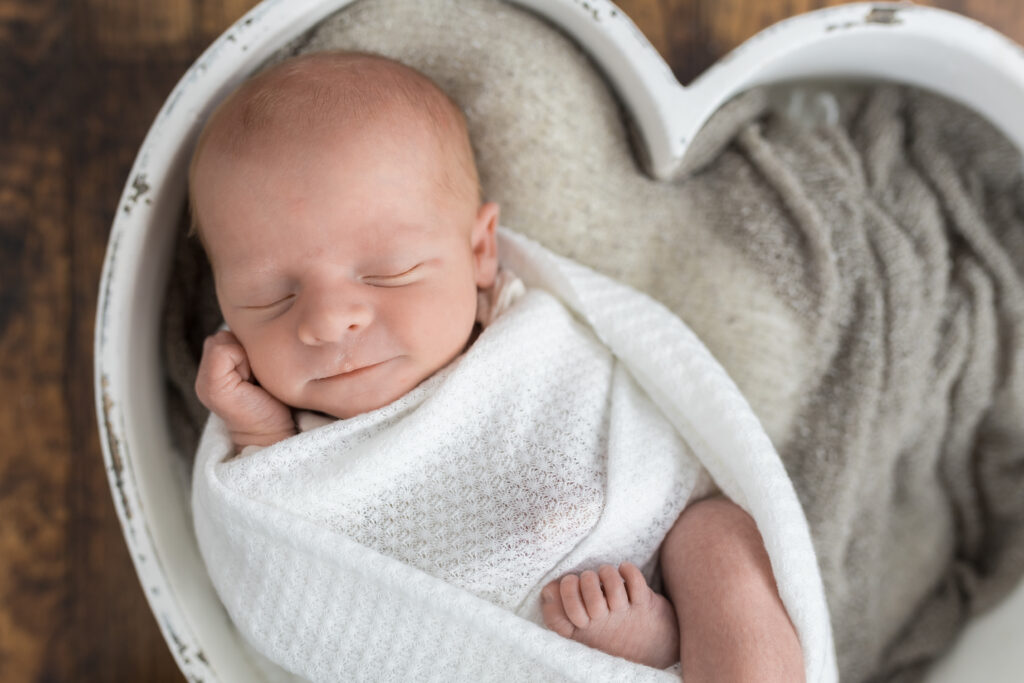 newborn baby in wrap during newborn studio photography
