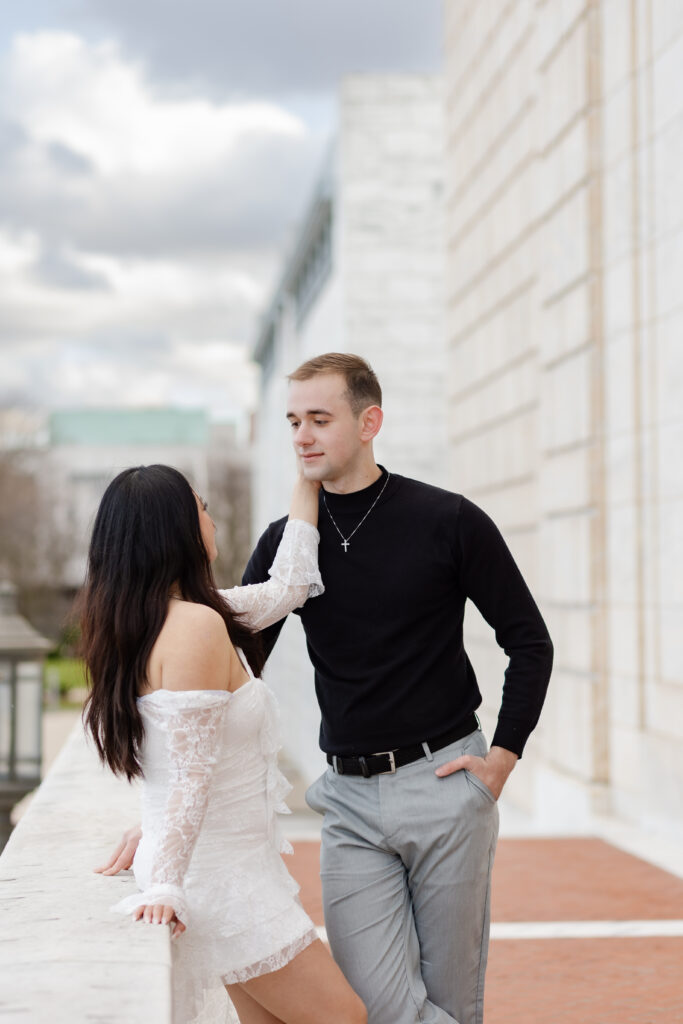 Woman touches man's face during Detroit engagement photography
