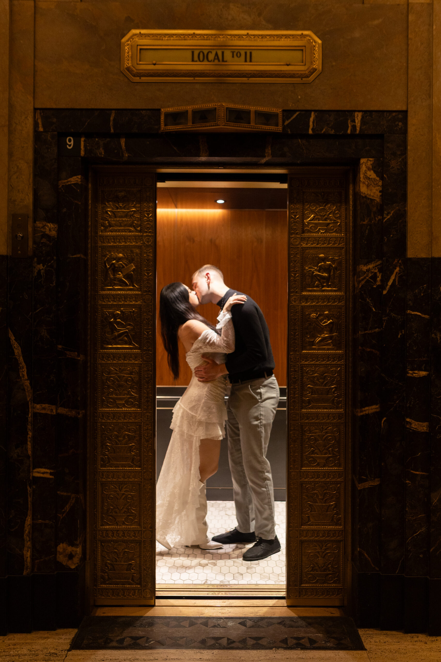 Man and woman kissing during Detroit engagement pictures