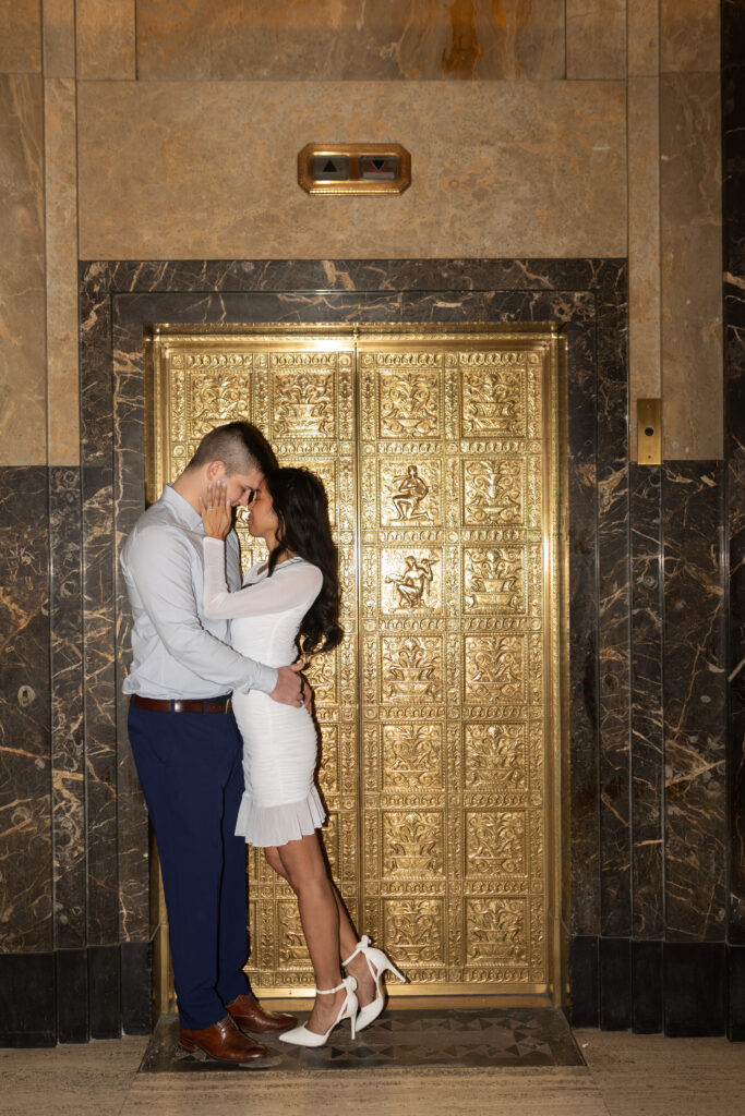 Couple kissing in elevator during Fisher Building engagement photos