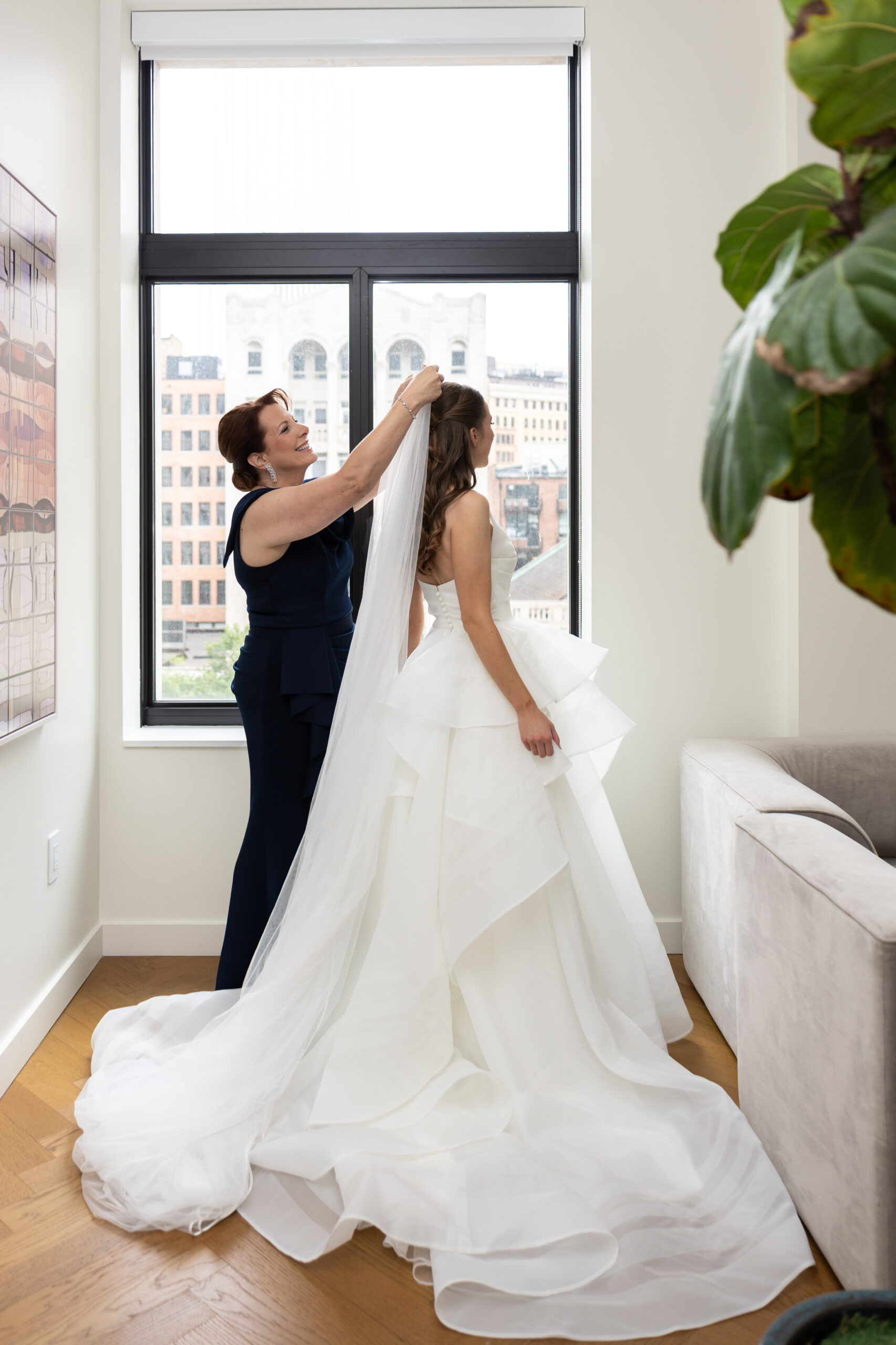 Mother puts veil on bride during Detroit wedding day at Book Tower