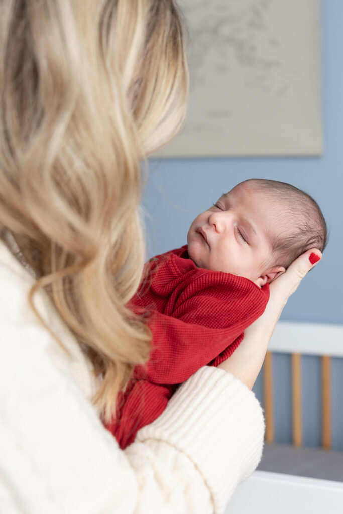 Mother looks at baby during at home Clarkston newborn photoshoot