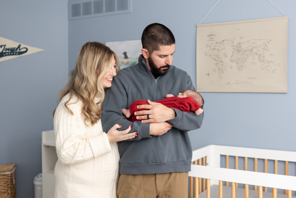 Mother and father hold baby during at home newborn photography photoshoot in clarkston