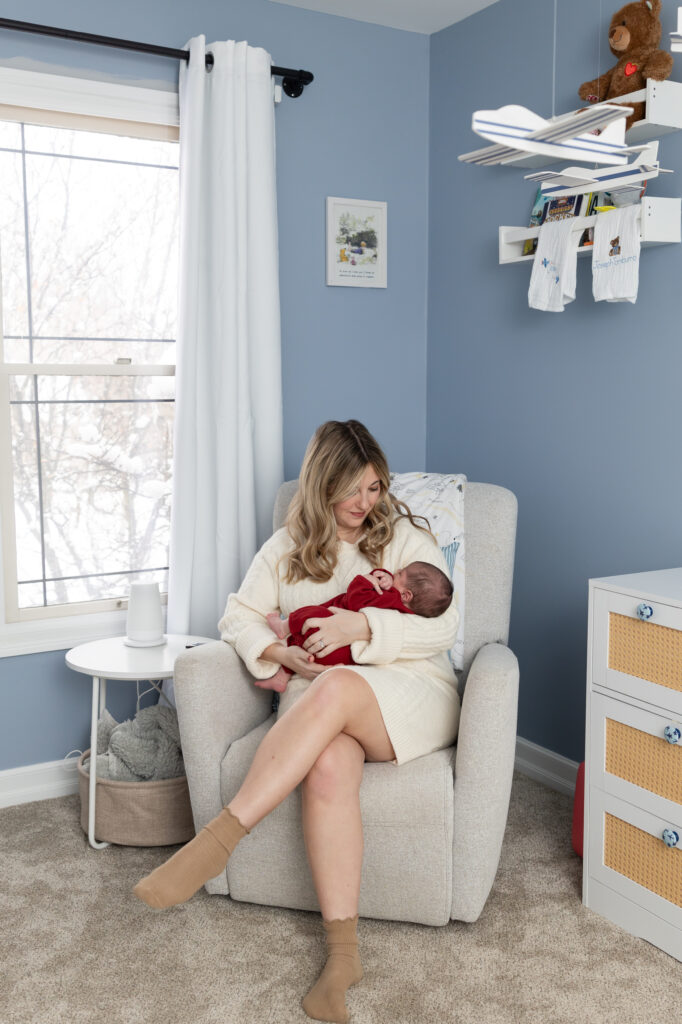 Mother holds baby in room during Clarkston newborn photography