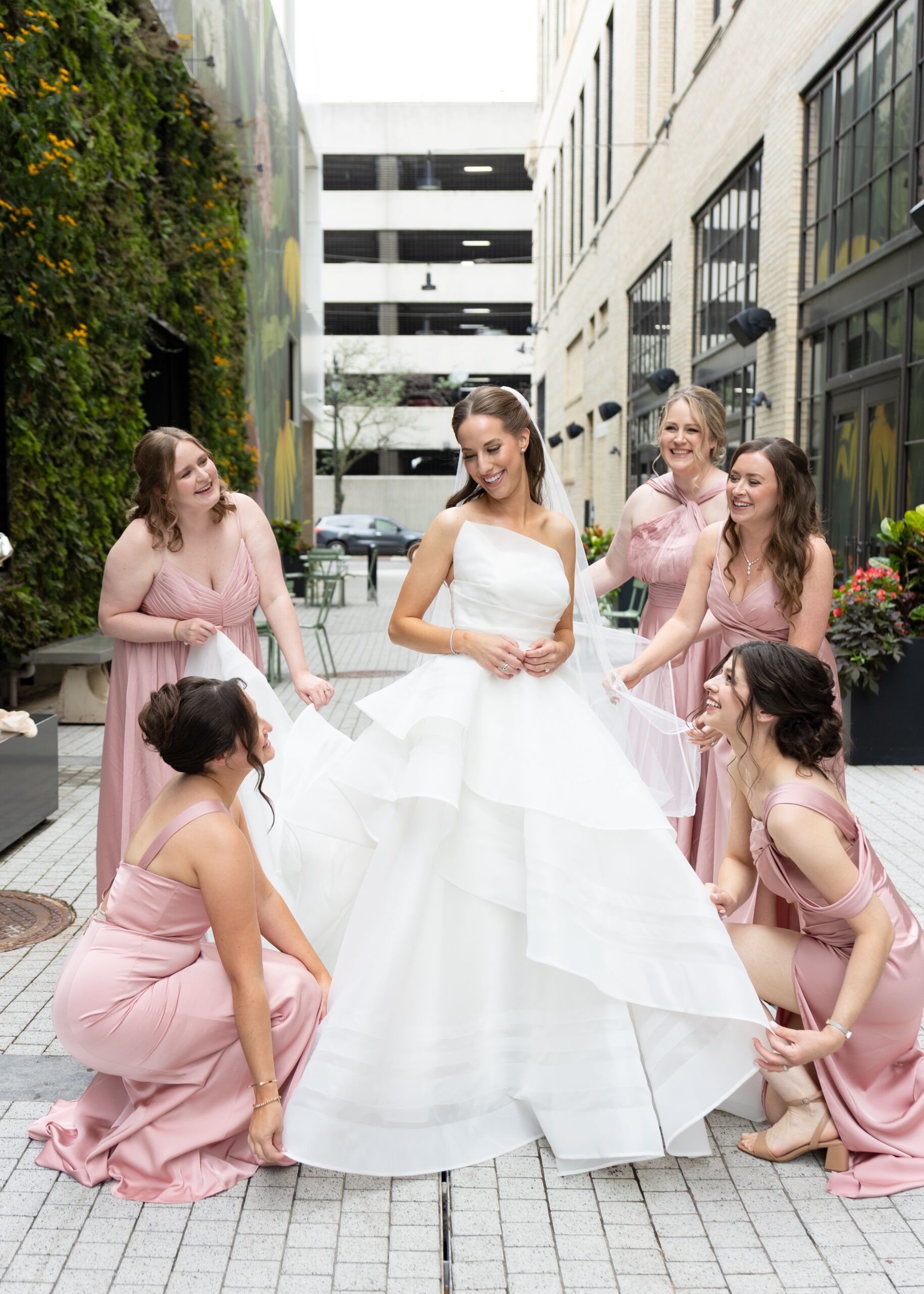 Biridesmaids help bride get ready during wedding in downtown Detroit