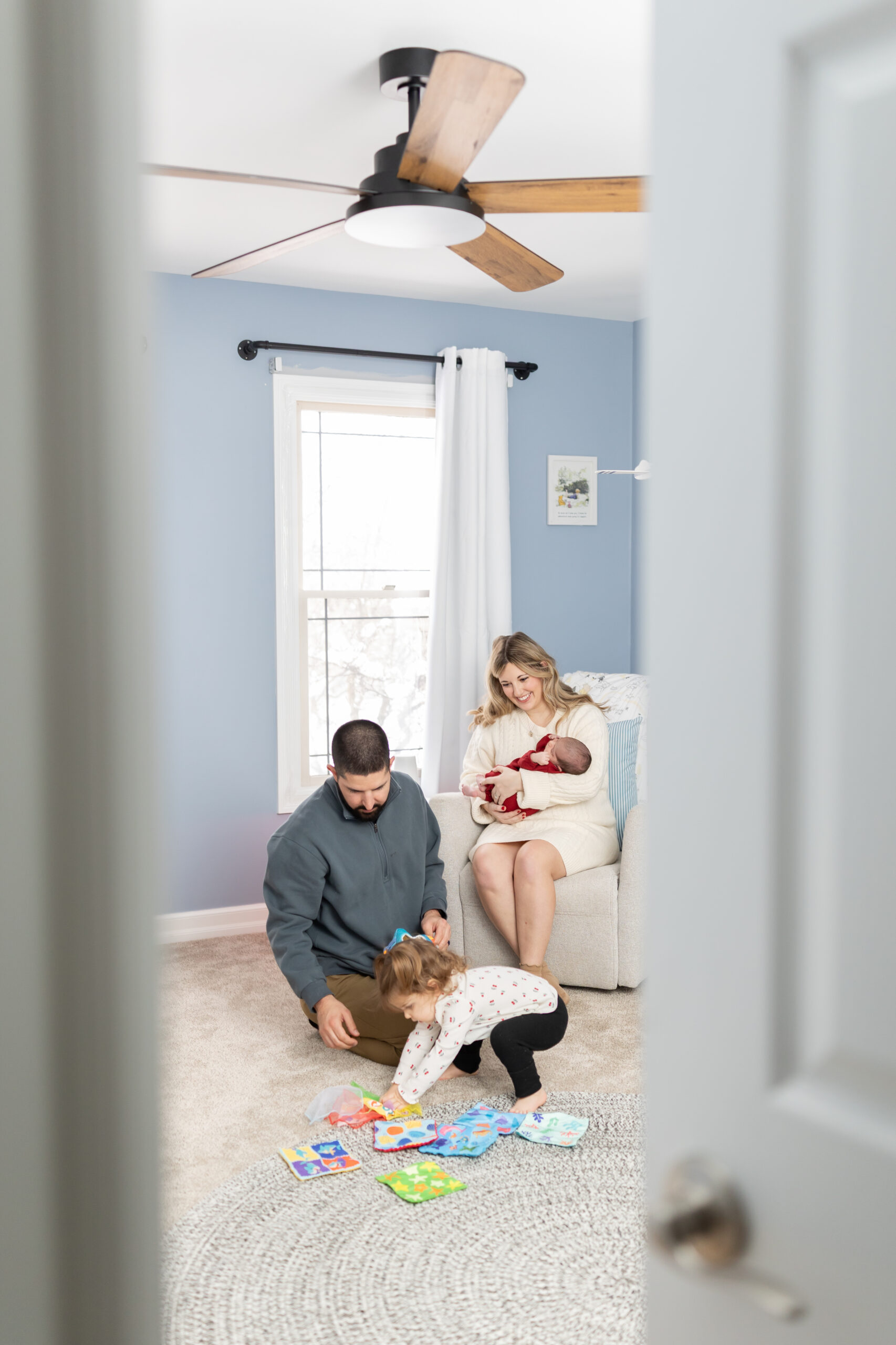 Family plays with daughter and son during Clarston newborn photography session