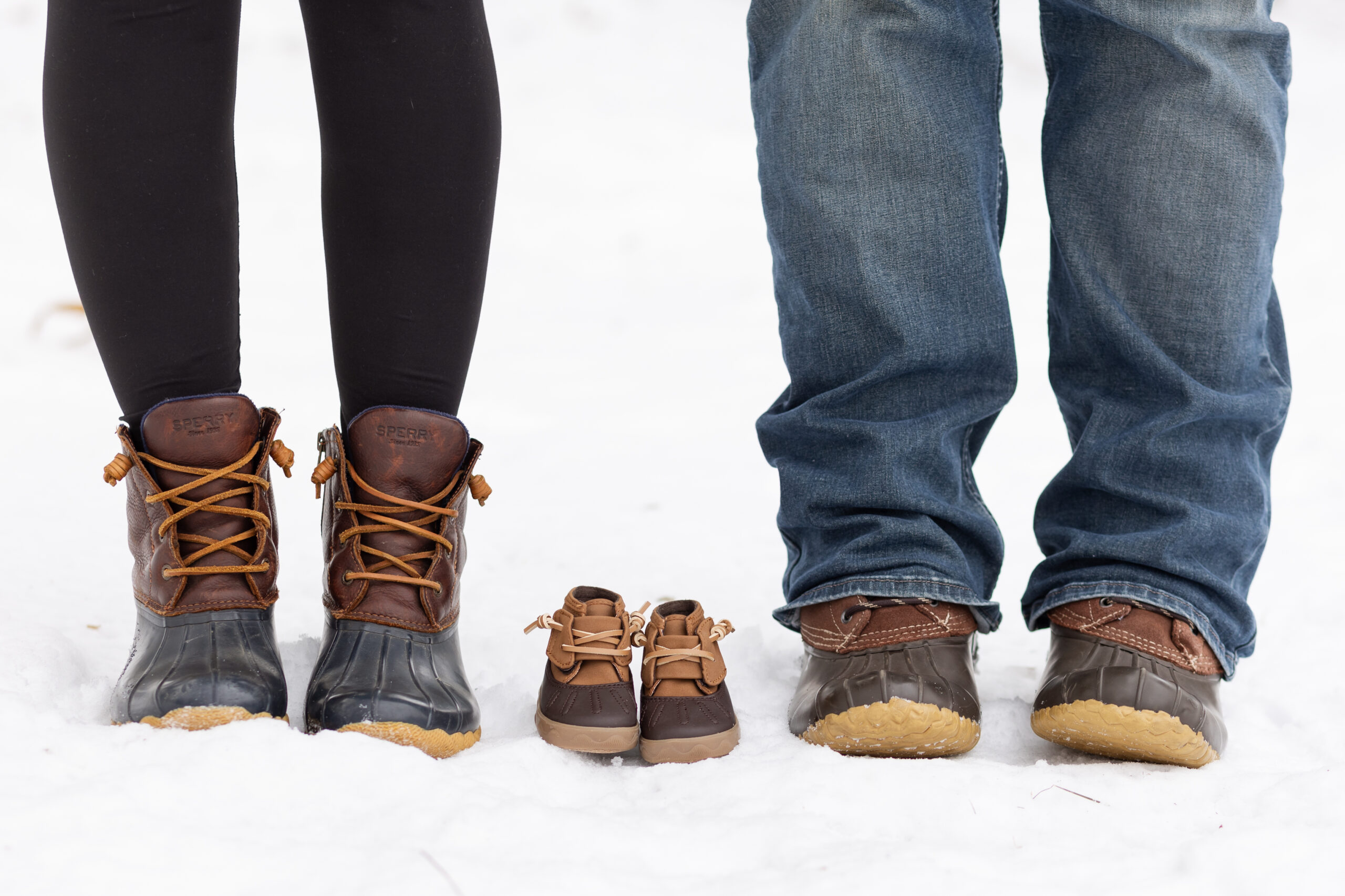 Three pairs of shoes in snow
