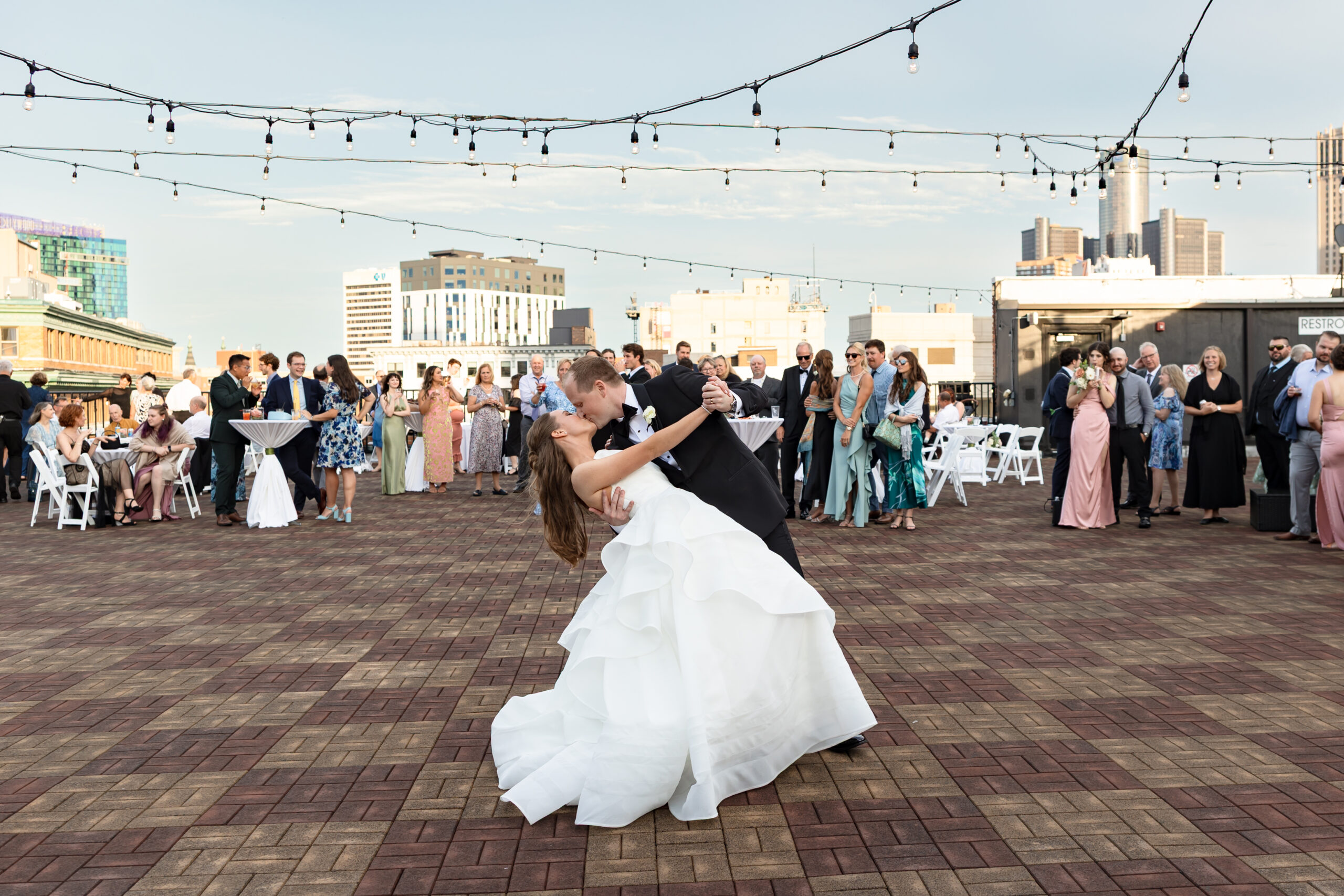 Bride and Groom kiss during first dance on Detroit Opera House rooftop