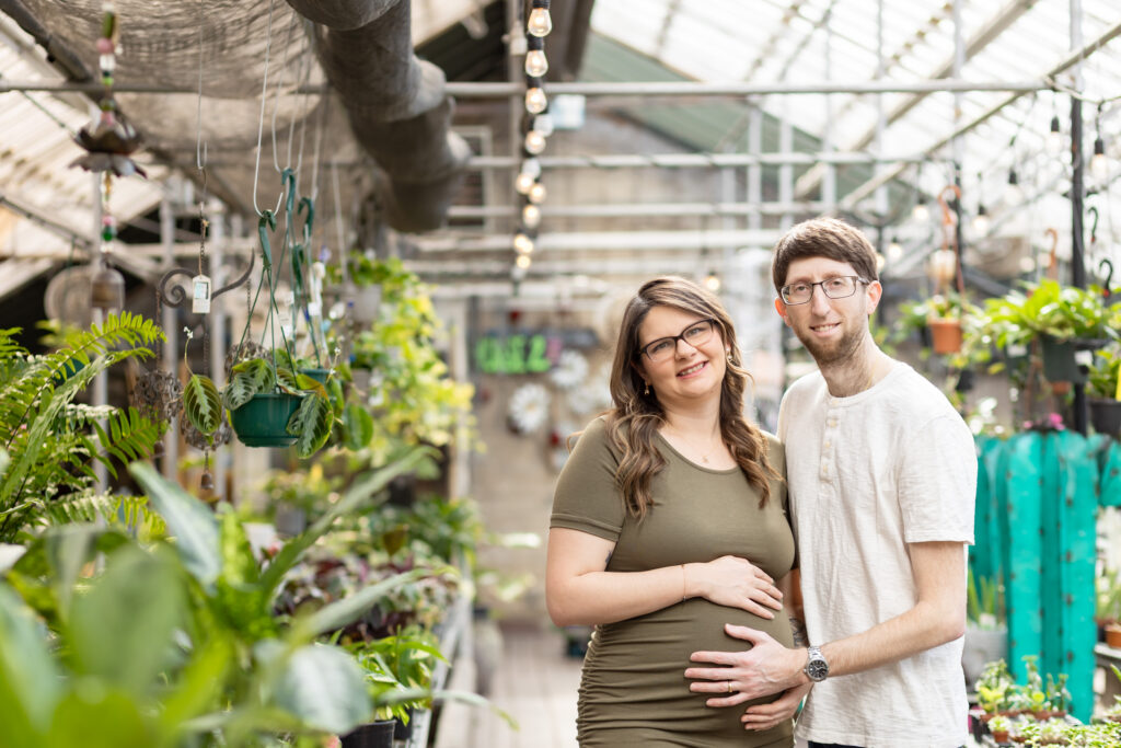 Pregnant woman and man smiling for maternity photographer in Oakland County MI