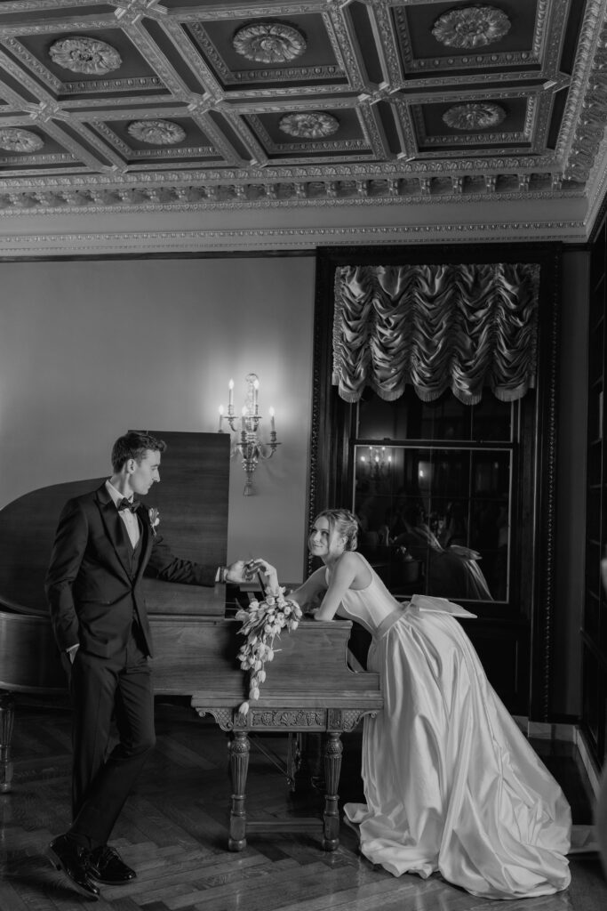 Bride and groom lead on piano during wedding photography at the War Memorial in Grosse Pointe MI