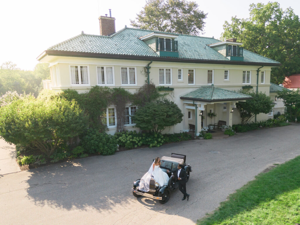 Bride and groom on vintage car during wedding photography at Belvedere Estate Wedding Venue

