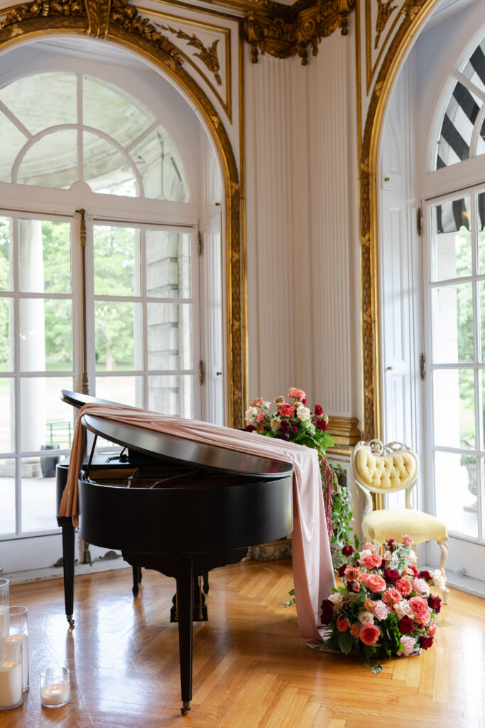 Piano decorated with flowers inside of Elkins Estate Wedding Venue